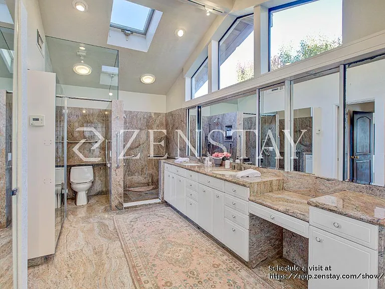 Well-appointed bathroom with elegant walk-in shower stall