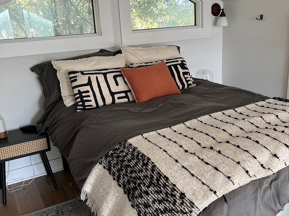 Lofted sleeping area. There are two small closets on either side of the bed.