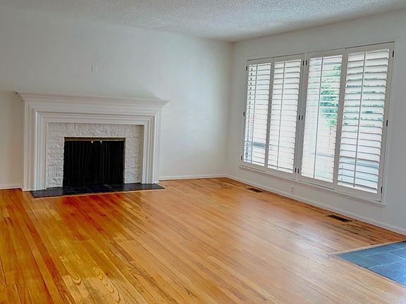 Living room with non-functioning fireplace.