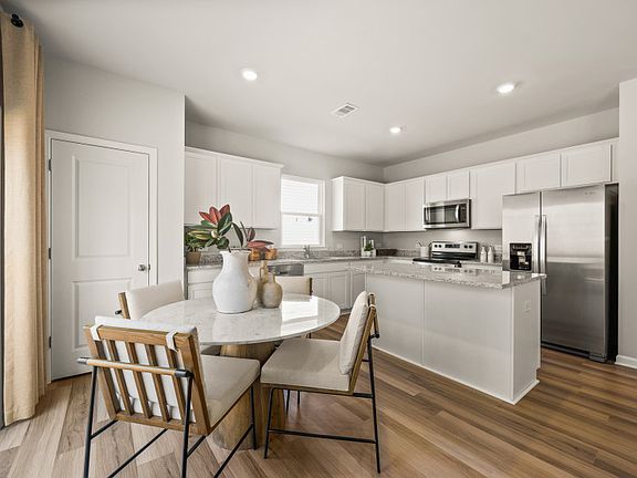 A cozy cafe nook that seamlessly transitions into the open kitchen.