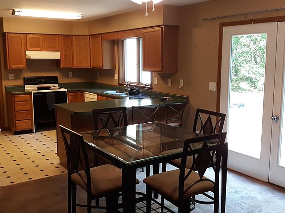 Dining and Kitchen with door to the outdoor deck and private backyard