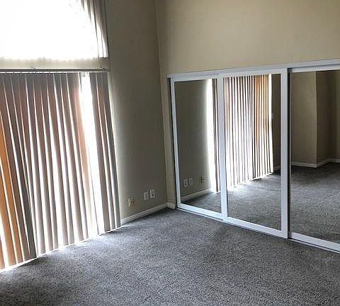 Master Bedroom with Vaulted Ceilings. New Mirror Wood Closet Doors