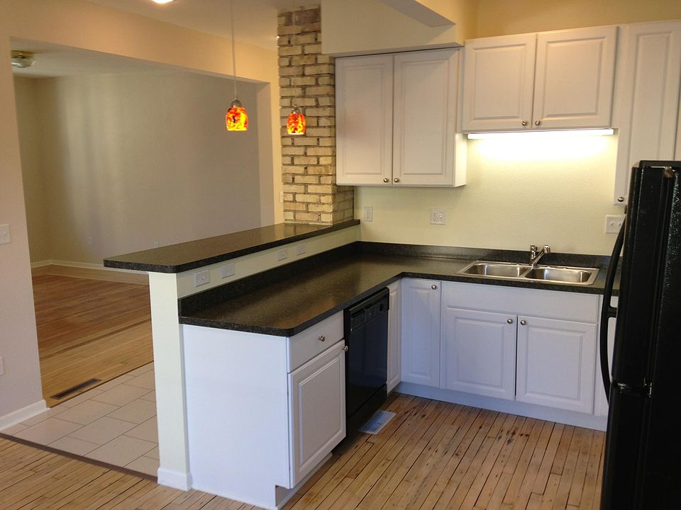 Kitchen with living room in background