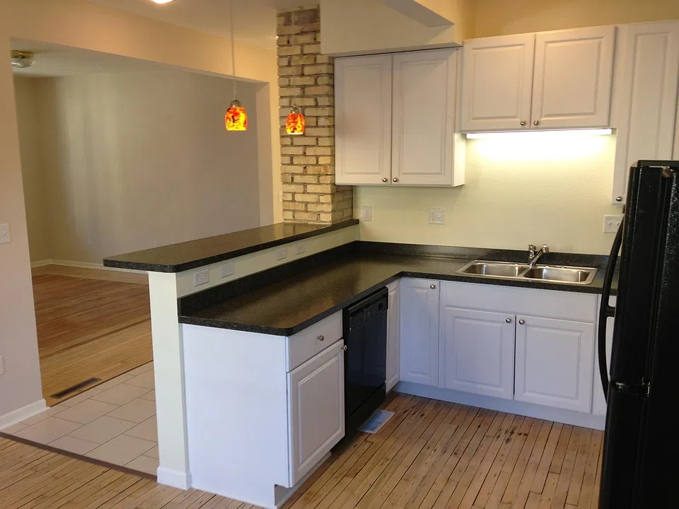 Kitchen with living room in background