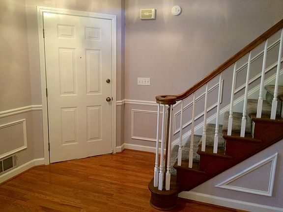 INTERIOR FOYER AND STAIRS TO SECOND FLOOR. TO THE LEFT IS THE COAT CLOSET AND TO THE RIGHT OF THE STAIRS IDS THE 1/2 BATH