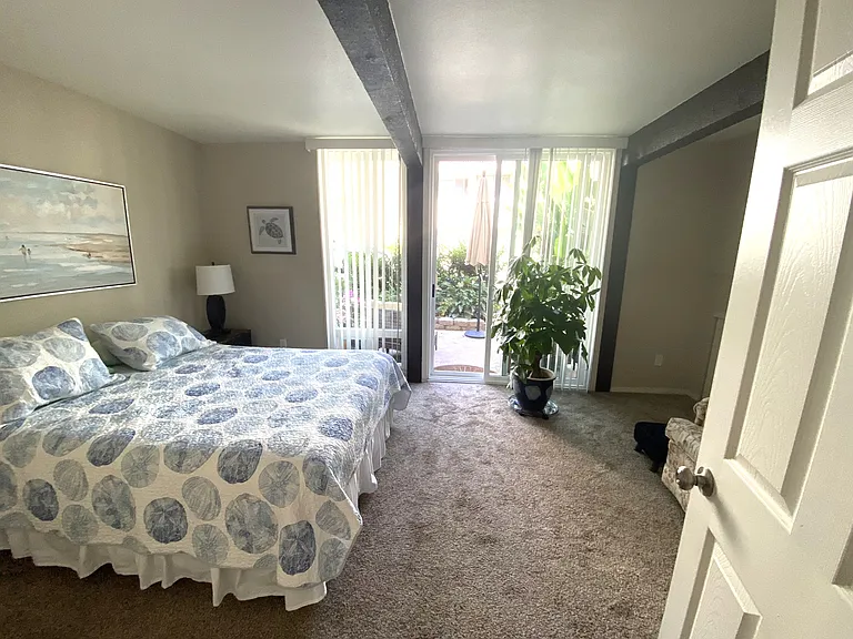 Walking into the bedroom from your private bath. The bed is queen size even though it looks larger in the picture
