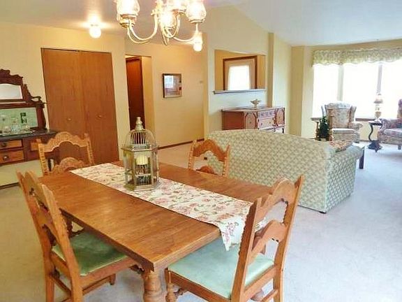 Another view of the dining and living room with the front entry behind the half wall.