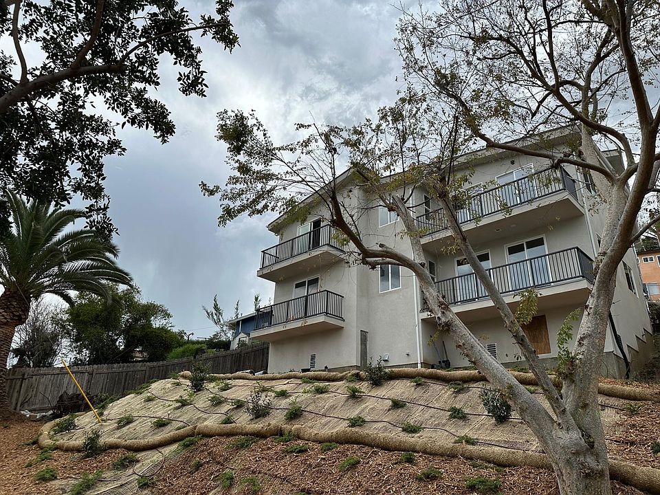 The exterior elevation as viewed from the backyard showing the balconies of both units