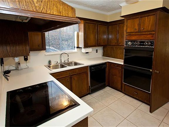 The Kitchen boasts solid-surface countertops