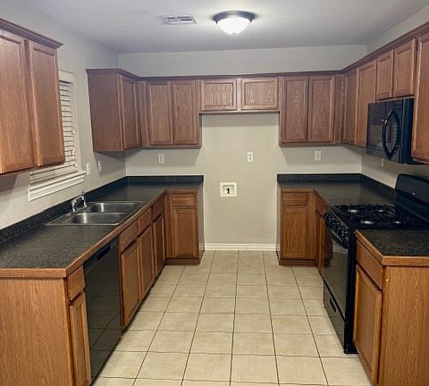Kitchen with stove, microwave, dishwasher, and garbage disposal.