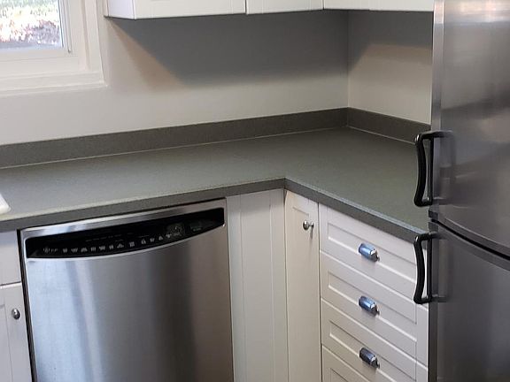 Italian tile floor, stainless dishwasher and European tall refrigerator.