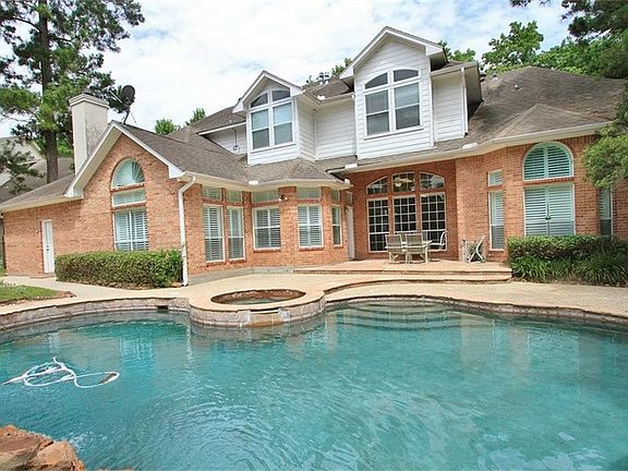 The Back of the Home features many windows overlooking the dazzling pool/spa! A partially covered pa