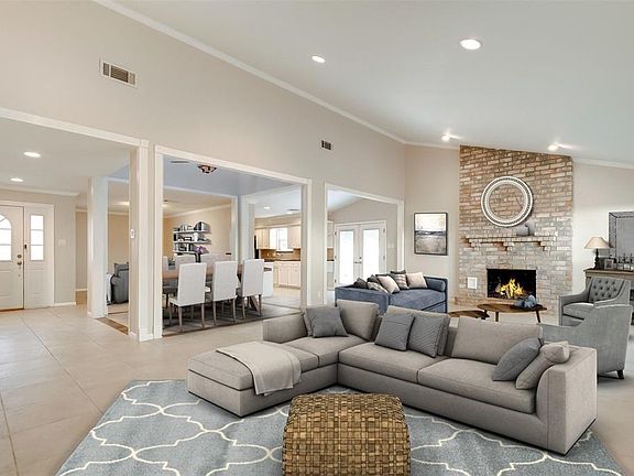 We have virtually staged this photo to show you how this home's wonderful open spaces come together to give you living and dining spaces that are comfortable and cozy.