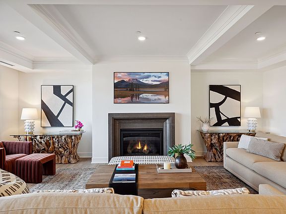 A handsome gas fireplace anchors one end of the living room