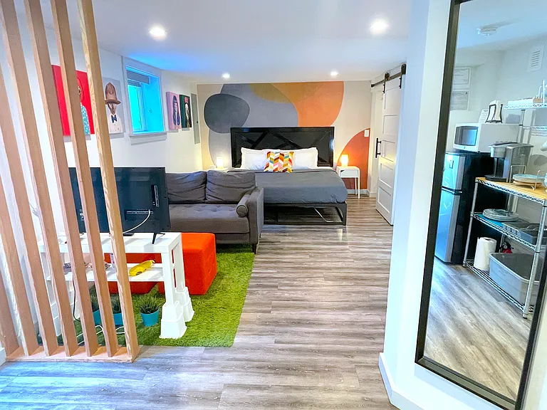 Daylight basement third bedroom. It includes a sitting area, kitchenette, and separate entrance.