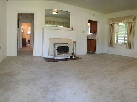 Inviting living room with fireplace insert.