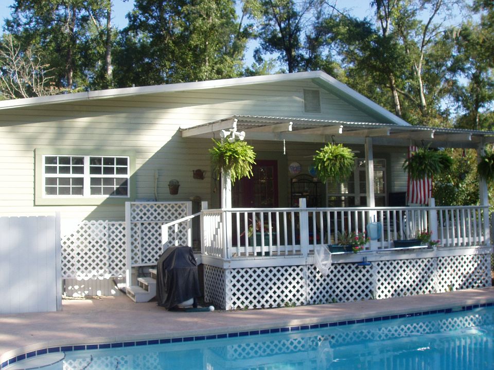 Side of house by inground pool