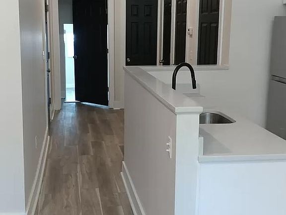 doors left to right: bedroom, half bathroom, laundry, storage closet, furnace closet