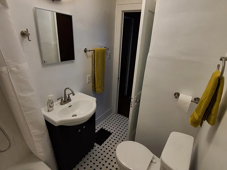 New Bathroom featuring Custom Tile Shower Walls and Flooring with brand new toilet, vanity, medicine cabinet, towel bars, and lighting