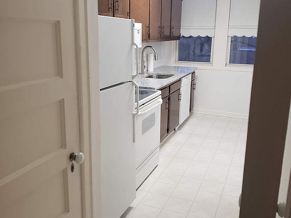 Kitchen from the hallway. Washer and dryer behind the door next to the refrigerator.