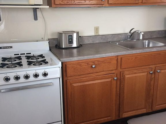 kitchen with gas stove, frig and other amenities