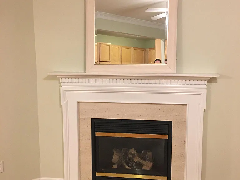 Gas fireplace with mirror above. Mirror can be removed and there's a tv mount for large screen tv if you want to place it above the fireplace.