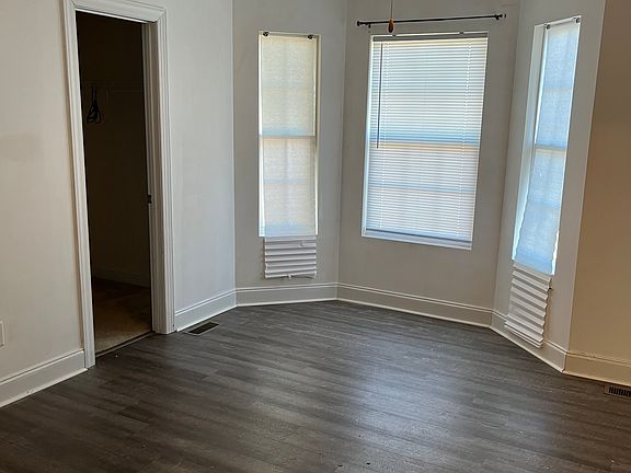 Master bedroom with full walk-in closet and bay windows.