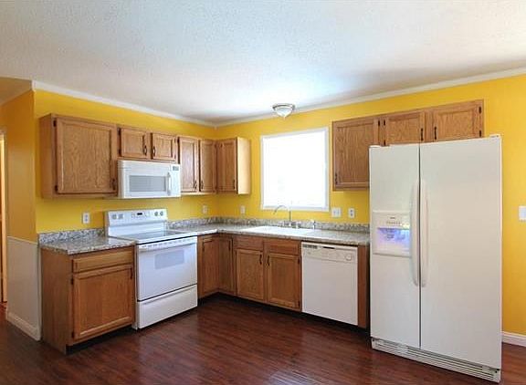 Bright Kitchen that leads out to the deck, fenced in yard and swimming pool.