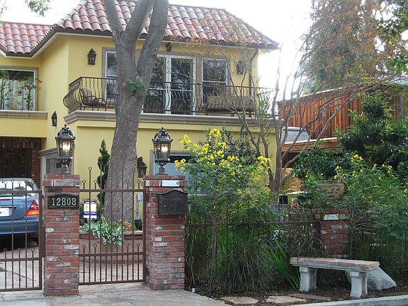 Artisan wrought iron gate door and curbside bench