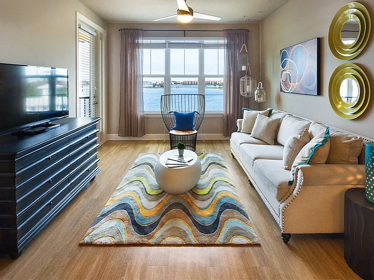 Inviting living rooms feature luxury vinyl plank flooring and ceiling fans