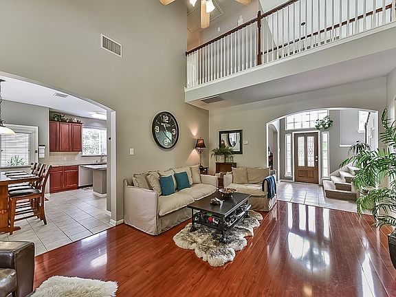 Great Room surrounds a fireplace and offers views of the expansive backyard and swimming pool.