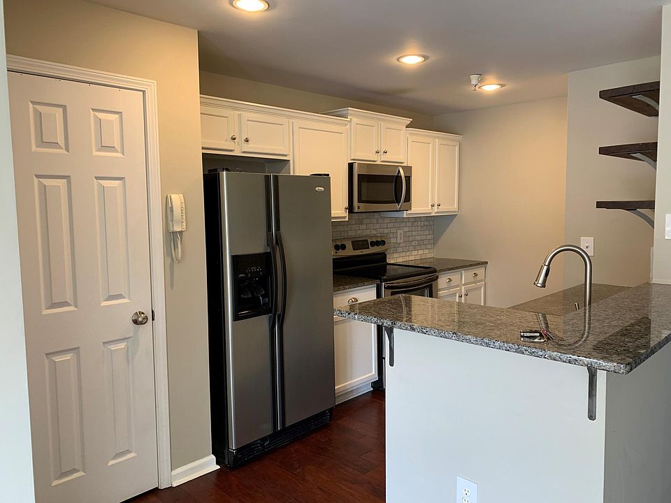 Coat closet and kitchen. 2 seater bar. phone to buzz people into building.