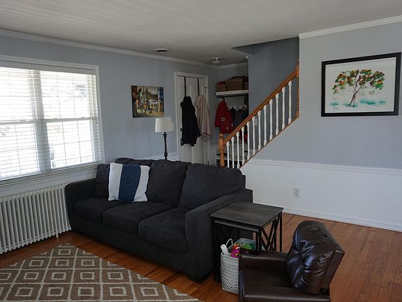 Living Room w /view of entrance & Stairs to 2nd floor w/ 2 BRs