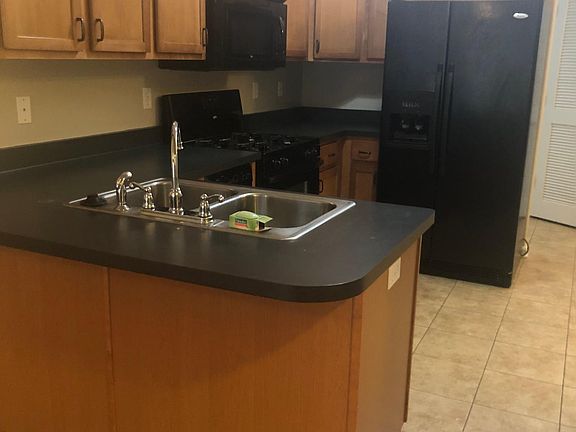 Sink, stove, microwave, refrigerator, and garbage disposal.