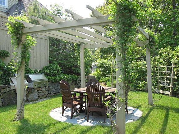 The side yard with its pergola and grilling area - a wonderful place to sit.