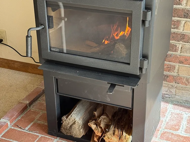 hearth with drolet wood stove and thermostatic fan
