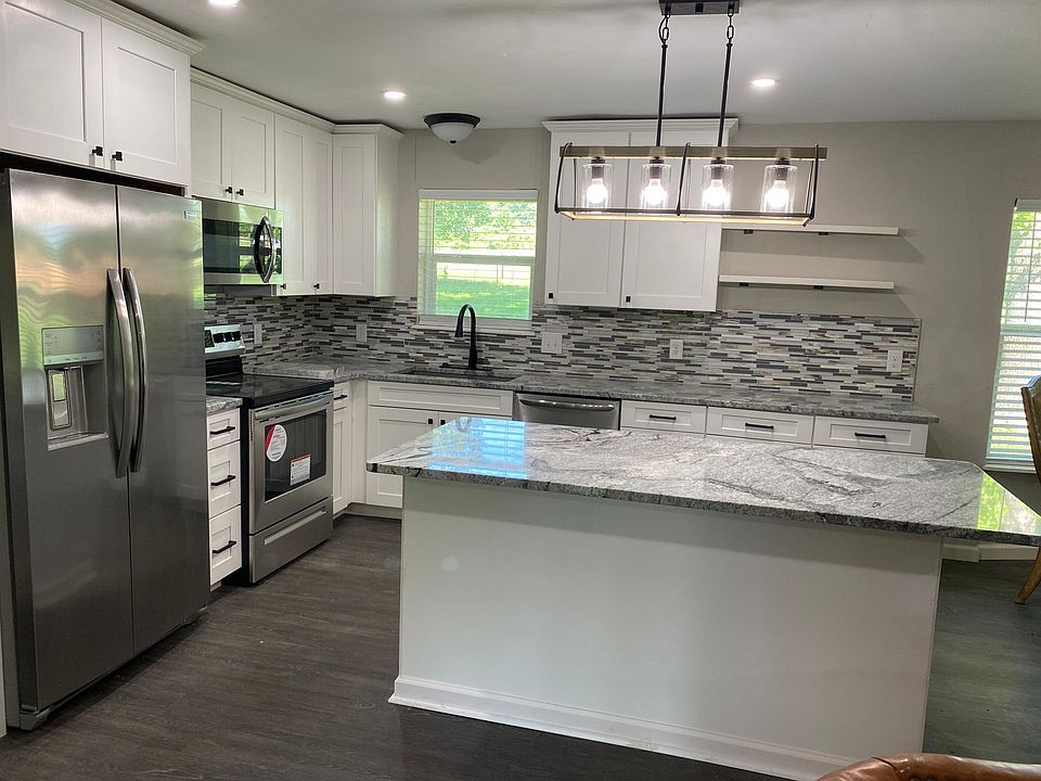 Fully updated Kitchen with island, granite countertops, New Cabinets and Backsplash. The home has New Stainless Steel Appliances and New Light Fixtures.