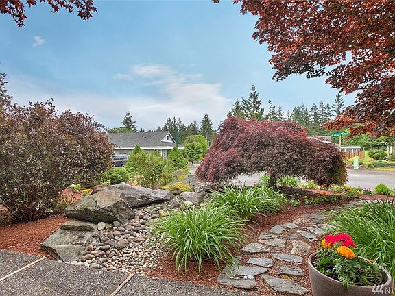 Here's the view you'll enjoy from the front of the home looking outward. It is lush and beautiful, and has a lovely dry creek bed and stone pathway.
