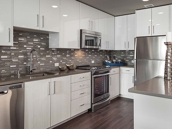 Modern kitchen featuring quartz countertops and stainless steel appliances