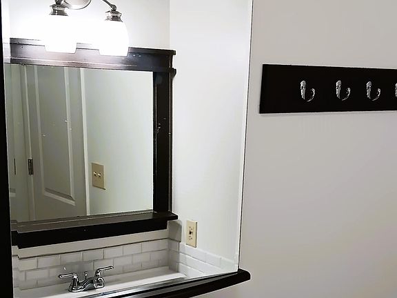 medicine cabinet reflecting vanity mirror