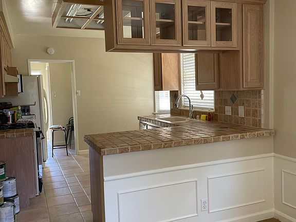 From dining room into kitchen. Stone floor and counter tops.