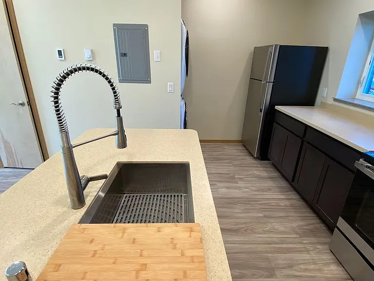 Kitchen sink and island, looking towards washer/dryer
