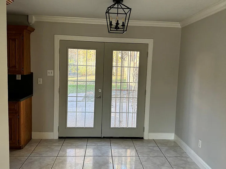 Dining/breakfast space featuring French door with access to the patio. Black fixture providing charm and character to this home.