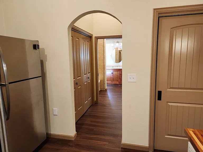 Arched passageway into the laundry room.