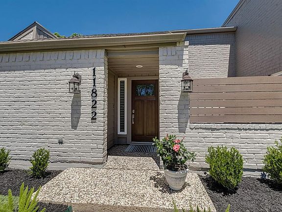 Welcome home to 11822 Drexelbrook! The owner just added the composite (maintenance free) IPE wood cladding to the front courtyar