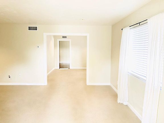 Looking into the house from front door. Living room continue to the left
