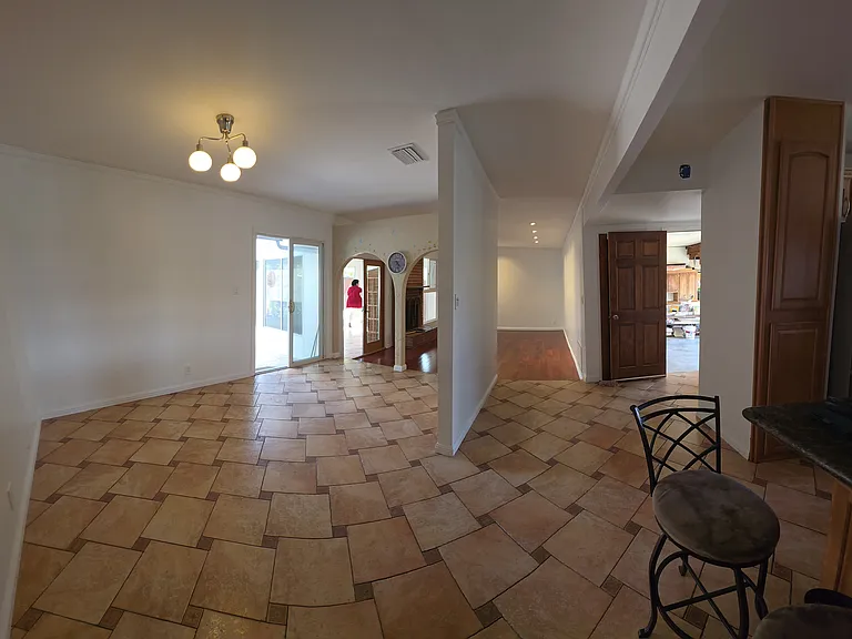 from kitchen hallway looking at garage formal living room and dining room including view of sunroom and backdoor pation
