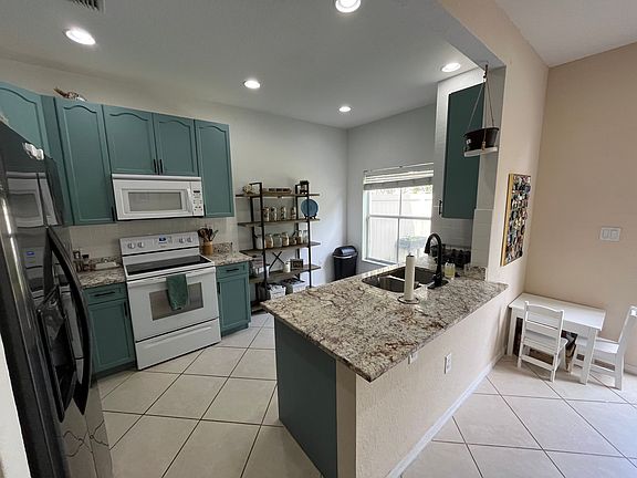 Kitchen with updated granite countertops, a brand new dishwasher and updated appliances and cabinets