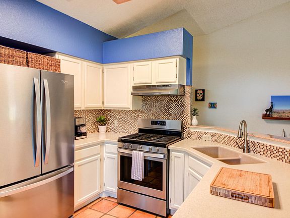 The kitchen features stainless steel stove and dishwasher. Refrigerator is provided but different from picture
