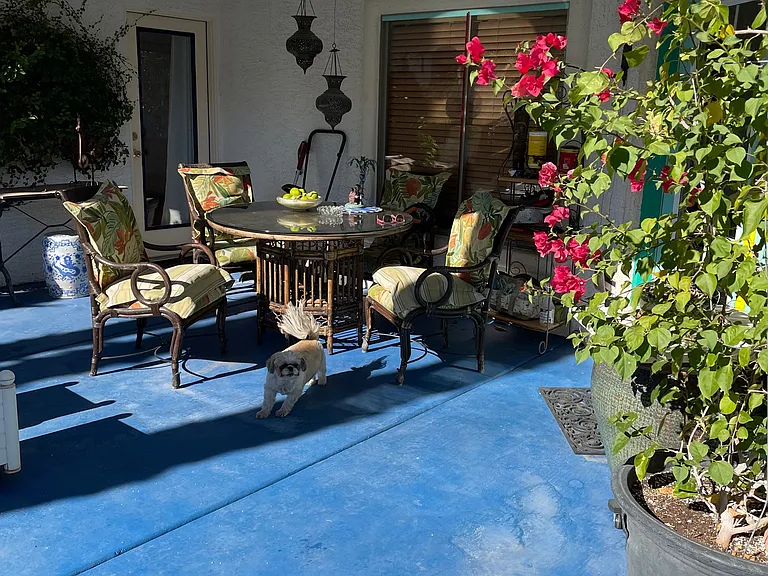patio with table & 4 chairs, entrance from unit